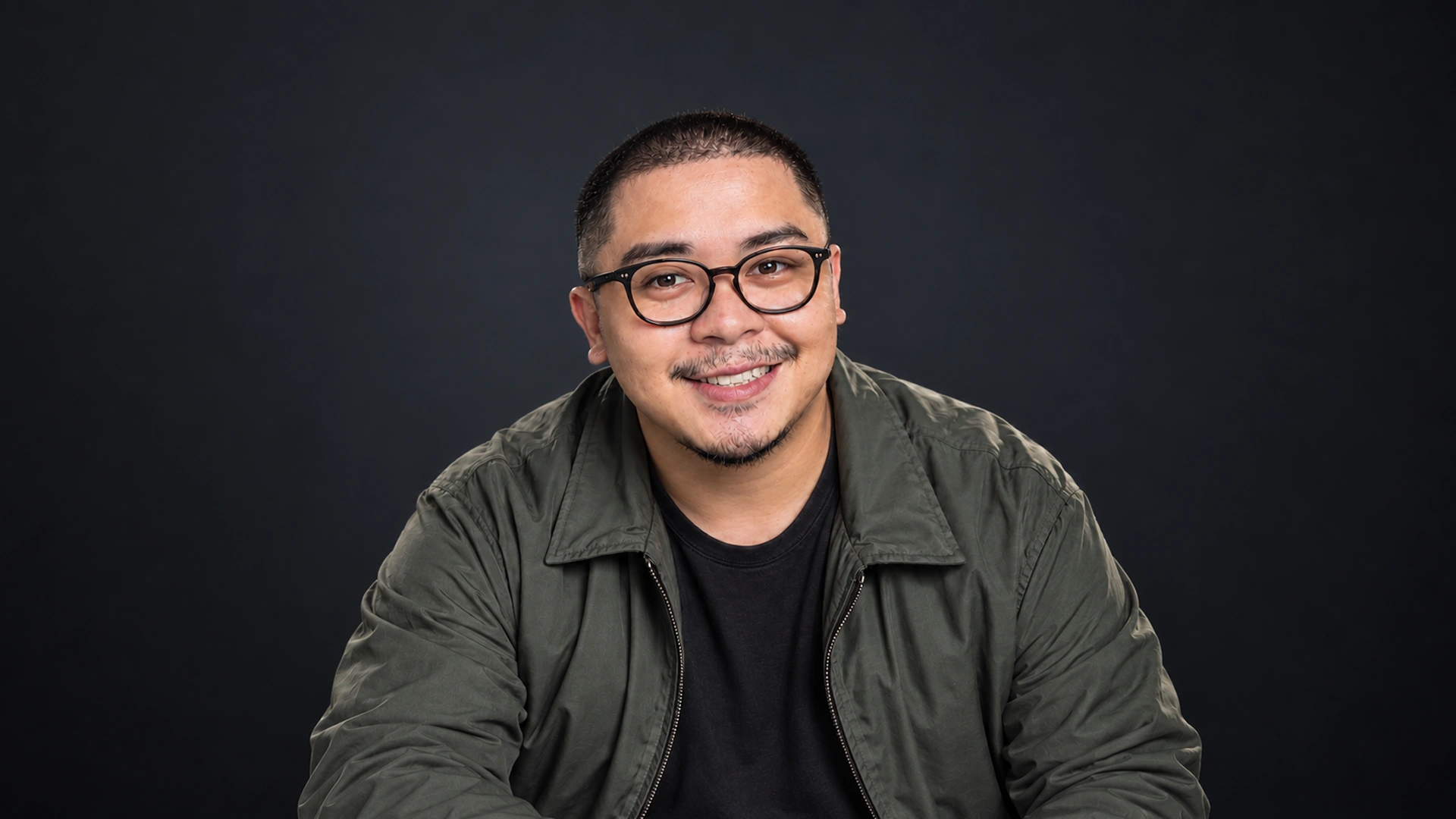 Rodel Luneta smiling in an olive jacket